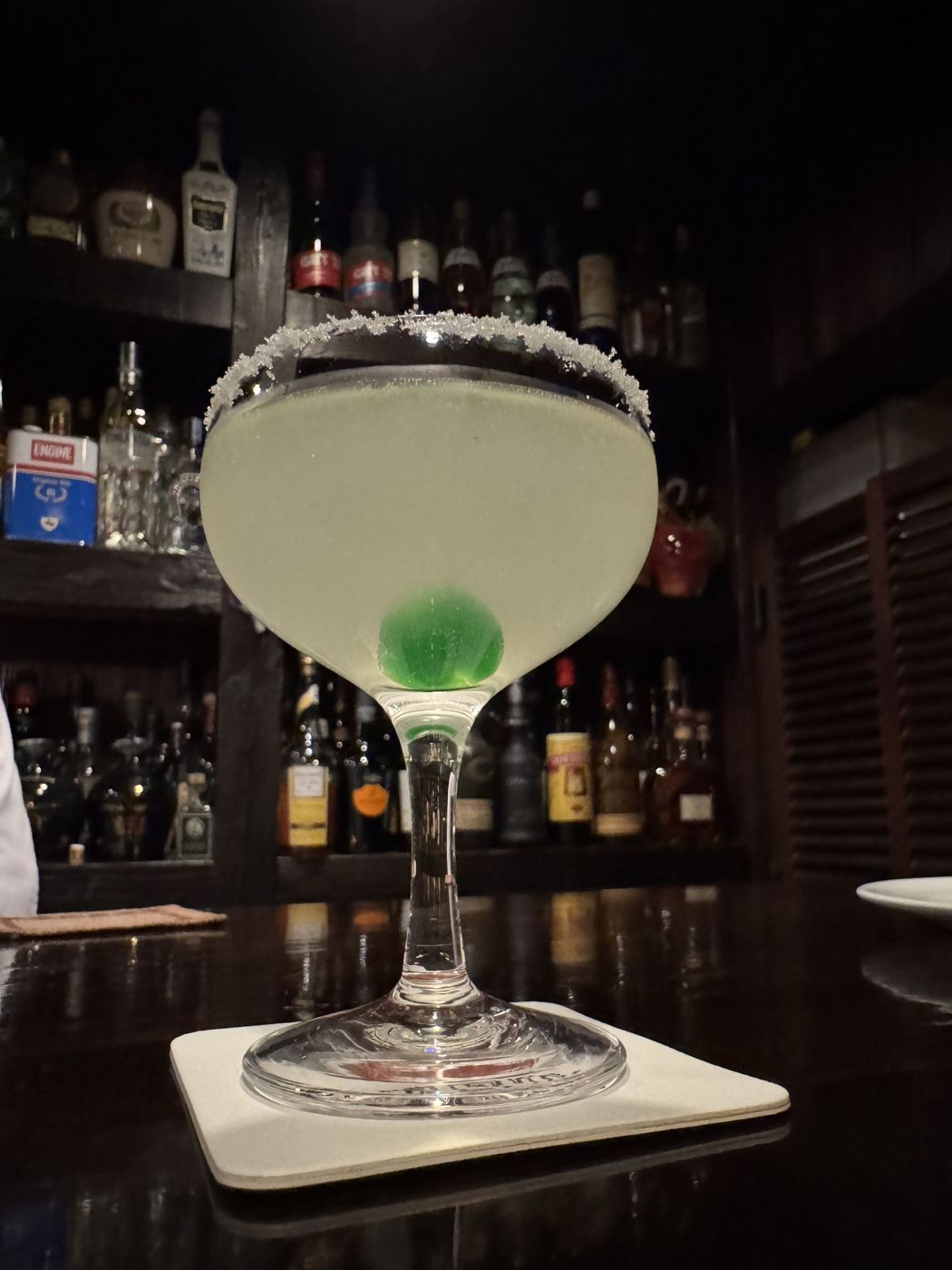 A cocktail at a dimly lit bar