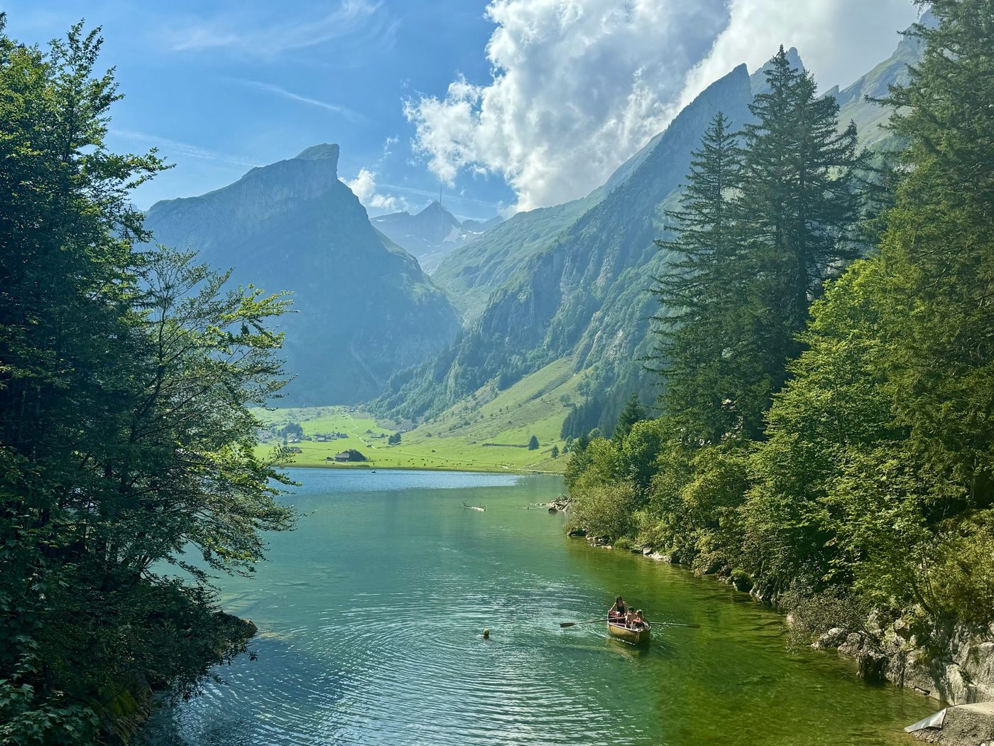 Rowboat on an alpine lake surrounded by mountains